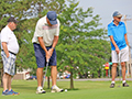  Guy putting on a golf course.